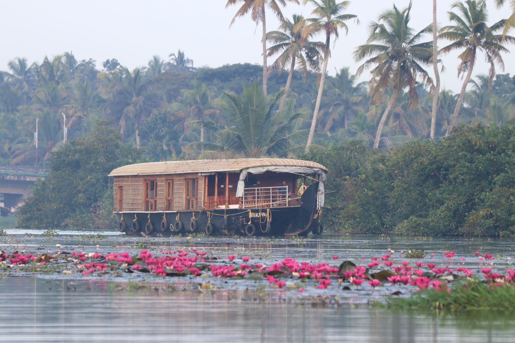 A houseboat gliding through the Kerala backwaters